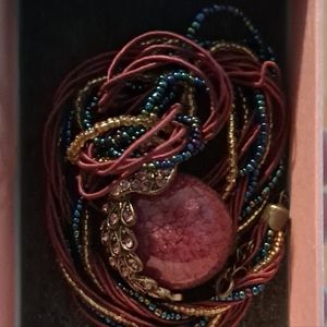 Multi string beaded/satin rope necklace with Peacock pendant